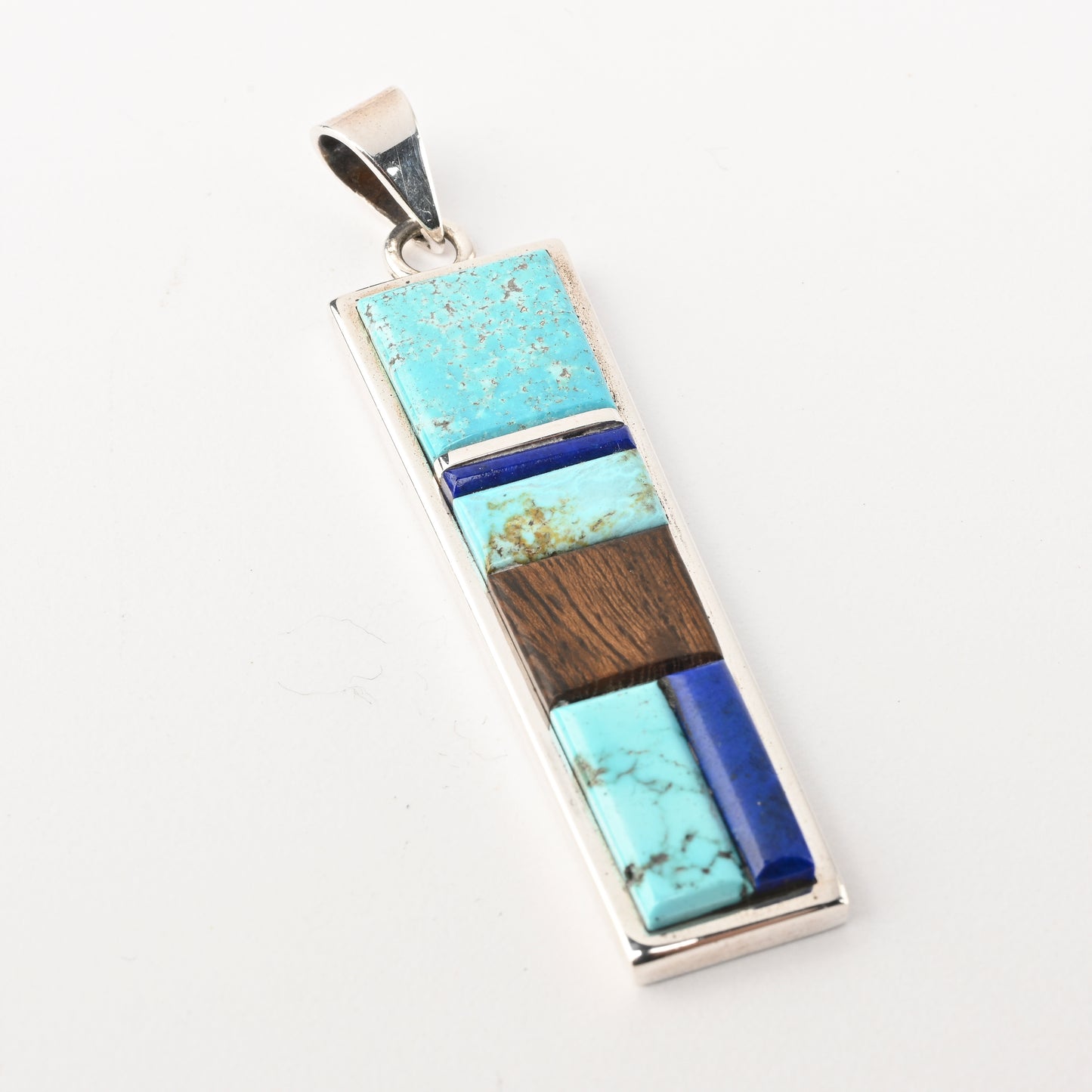 Sterling silver pendant with inlay of turquoise, lapis, and ironwood