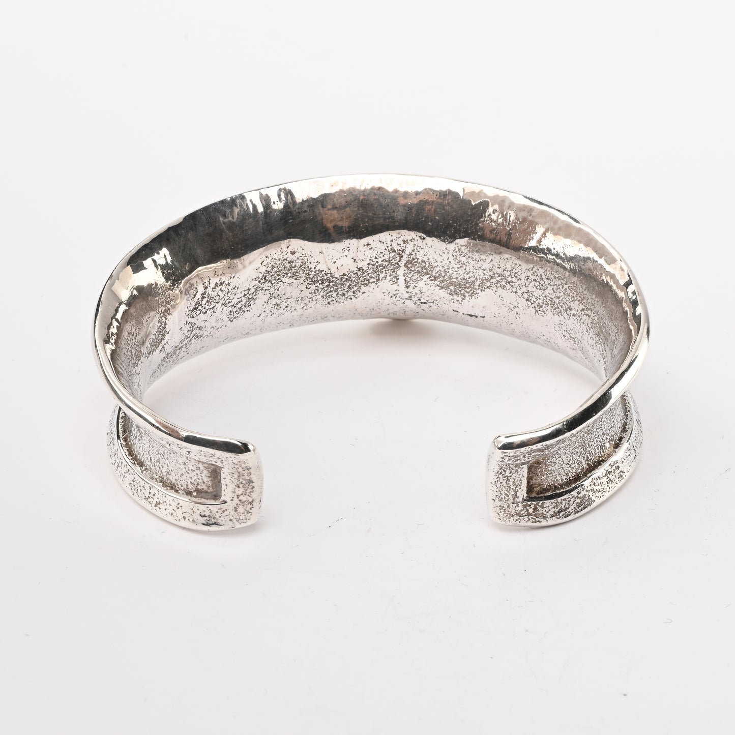 Tufa-cast, Sterling Silver Cuff Bracelet decorated with Avanyu (water serpent) and one Turquoise stone