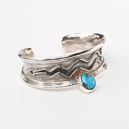 Tufa-cast, Sterling Silver Cuff Bracelet decorated with Avanyu (water serpent) and one Turquoise stone