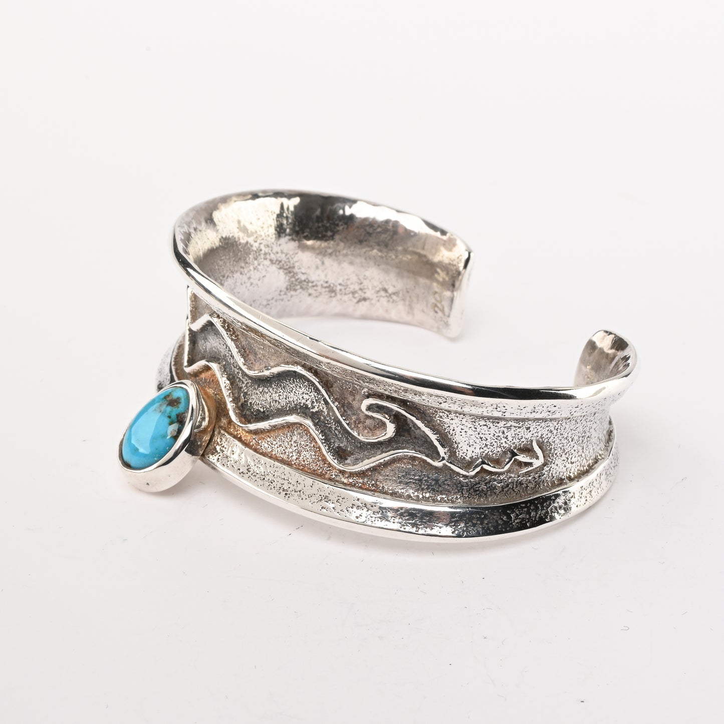 Tufa-cast, Sterling Silver Cuff Bracelet decorated with Avanyu (water serpent) and one Turquoise stone