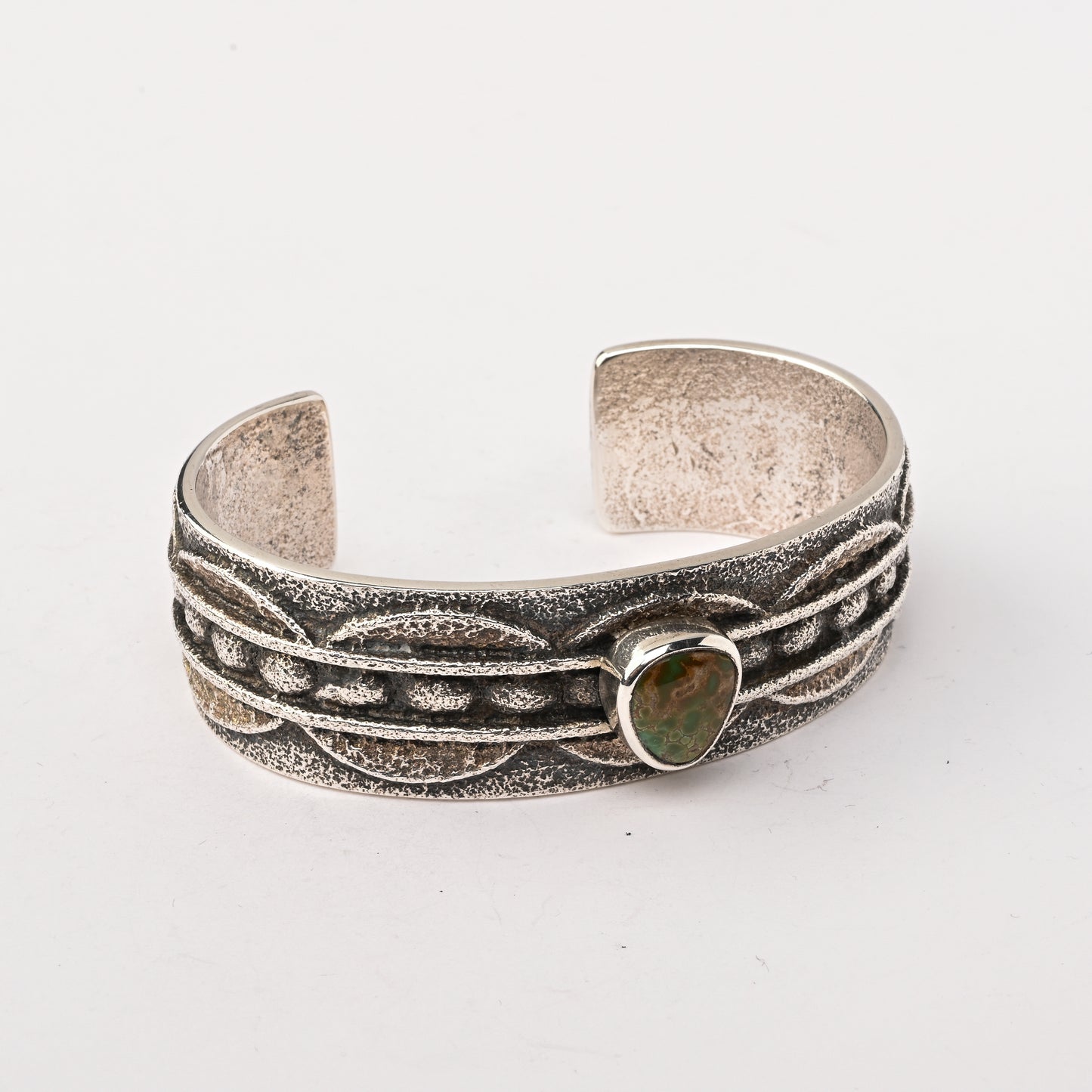 Sterling silver, Tufa-cast Cuff Bracelet set with a single Turquoise Stone