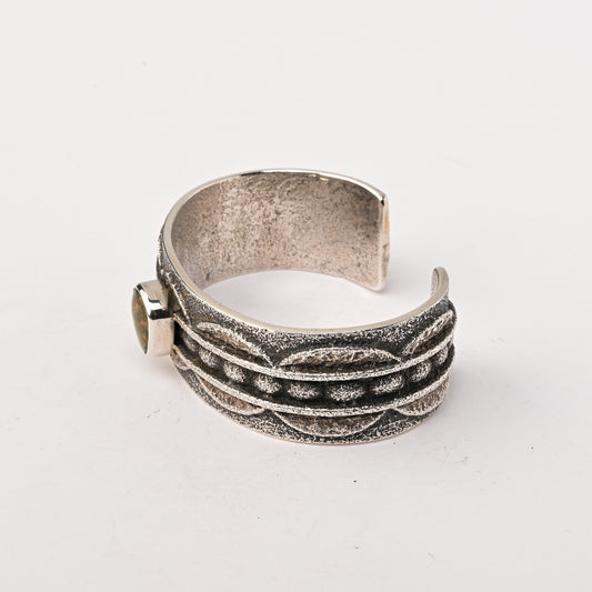 Sterling silver, Tufa-cast Cuff Bracelet set with a single Turquoise Stone